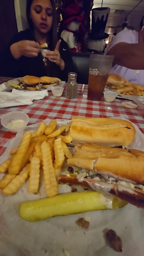 A salad and fries served beside pizza.